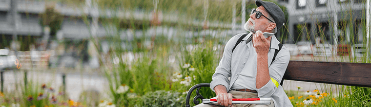 Blind old man using his smartphone